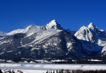 Buck and Wister Mountain peaks in the Grand Teton range in the Central Rocky Mountains of Wyoming USA with the banks of the Snake River in the foreground