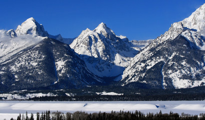 Buck and Wister Mountain peaks in the Grand Teton Mountain Range with the banks of the Snake River in the foreground in Grand Tetons National Park in Wyoming USA