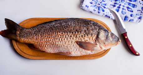 The fish on a cutting board with a knife