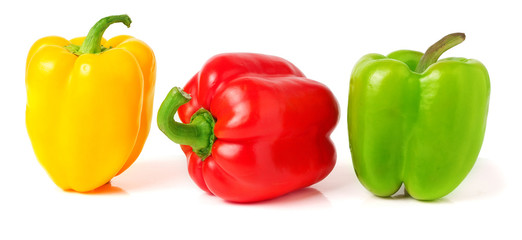 colored peppers over white background