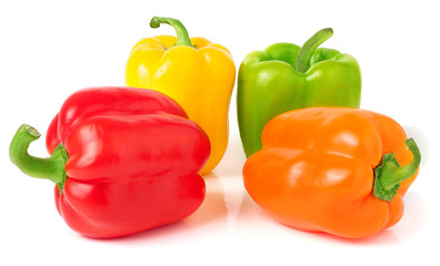 colored peppers over white background