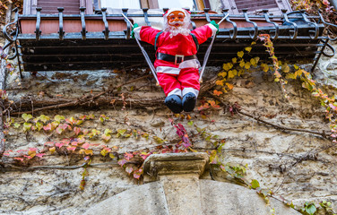 Hanging santa claus in the streets of a medieval town