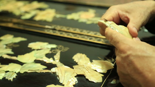 Traditional nacre craftsman working  with floral motifs