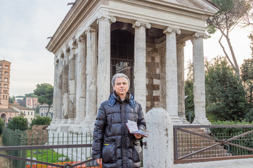 modern man near ancient Roman Temple