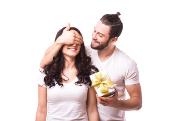 Man keeps his girlfriend eyes covered while she giving a gift , romantic surprise for Valentine...