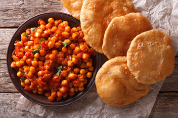 Delicious Indian Chana masala and puri close-up. Horizontal top view
