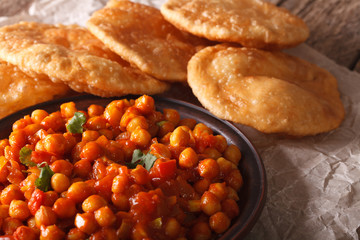 Indian Cuisine: Chana masala and puri bread close-up. horizontal
