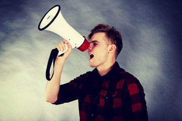 Young man shouting in megaphone.