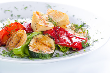 Assorted vegetables grilled on a white background