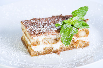 Tiramisu with strawberry, chocolate and powdered sugar
