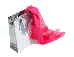 Silver gift bag and  pink silk scarf isolated on white