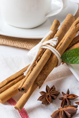 close up of ring-shaped cake with icing sugar, cream, mint, cinn