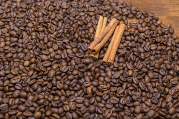 coffee beans and cinnamon on the table the whole texture of coarse brown lot