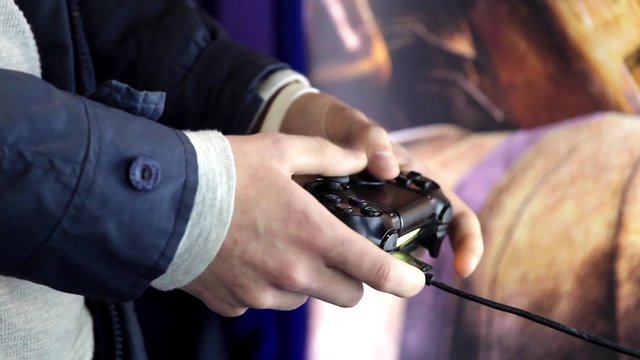 Playing games console close up, man playing video game with joystick 