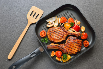 Grilled pork chops and vegetables on the grill pan