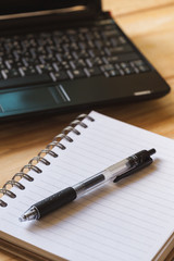 Pen, Blank notepad and laptop on the office.