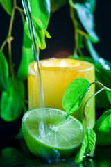 Yellow candle light with water falling on lemon. Spa concept