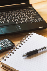 Pen, Blank notepad and laptop on the office.