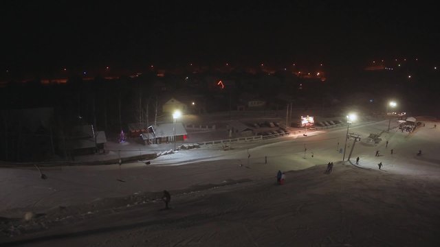 The ski resort during night time, aerial view