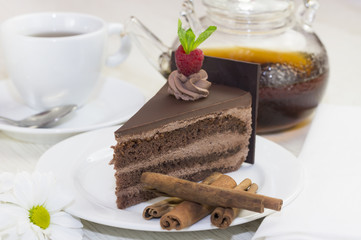 piece of chocolate cream cake on a white background in the restaurant