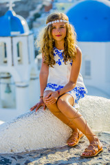 Young and beautiful girl in Oia - Santorini, Greece
