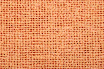 Fabric texture. Cross-stitch pattern textile. Orange carpet. Canvas. For the background. Surface of colorful in macro style. 