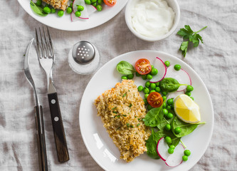 Baked salmon with lemon bread crust and fresh vegetable salad with peas, spinach, radishes and cherry tomatoes. Delicious healthy dinner