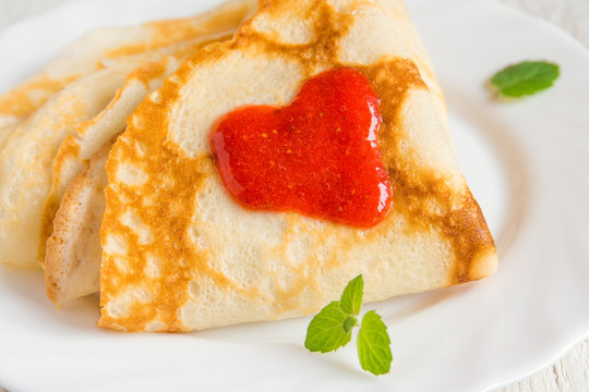 Pancakes with strawberry jam heart