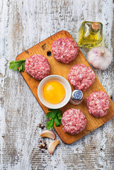 Raw meatballs on a chopping board