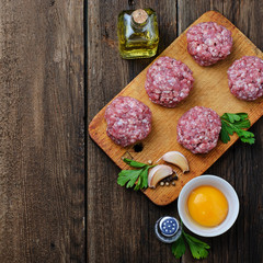 Raw meatballs on a chopping board
