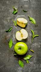 Green Apple whole and cut slices with leaves .