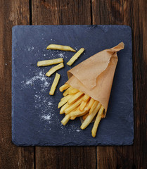 French fries in paper wrapper © Yulia Furman