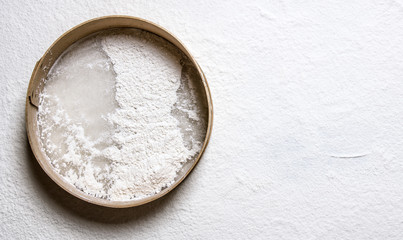 Baking the dough , wooden sieve with flour.