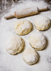 Preparation of the dough. The prepared dough with flour and with a rolling pin.