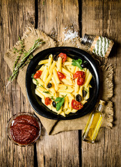 Pasta with tomatoes, olives and herbs.