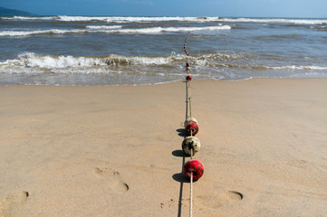 Buoys on a rope leading into the ocean