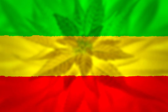 Cannabis bud on grunge rastafarian flag.