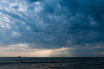 Fototapeta na wymiar Stormy sky over ship in the sea