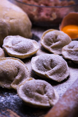 Raw meat dumplings. Ingredients for making dumplings: dough, minced meat, eggs on the wooden background. Selective focus