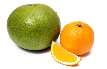 Green sweet grapefruit and orange with a cut piece isolated on white