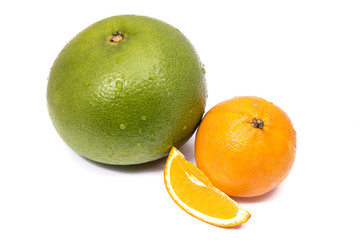 Green sweet grapefruit and orange with a cut piece isolated on white