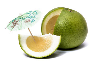 Fototapeta na wymiar Sweet green grapefruit with umbrella and cut piece isolated on white