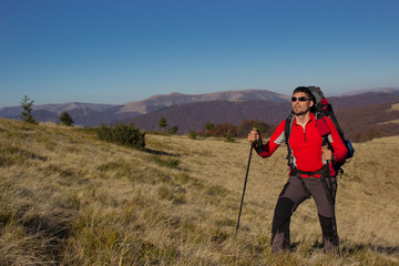 Hiker hiking in the mountains on a sunny day.