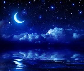 Starry Night With Crescent Moon On Sea
