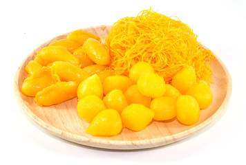 thai sweetmeat dessert made from egg and sugar on wood dish isolate on white background, top view