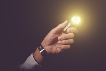 Businessmnan holding light bulb