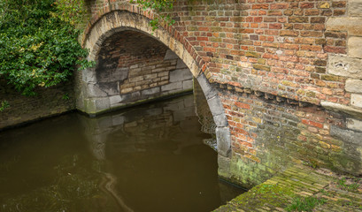 Obraz premium Masonry stone arch in the ancient Dutch city of Delft