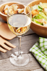 Fresh healthy caesar salad and white wine