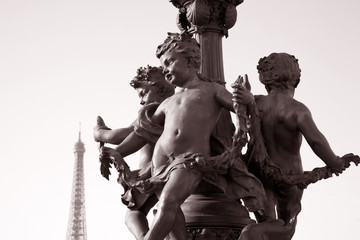 Figure on Pont Alexandre III Bridge with the Eiffel Tower in the Background in Sepia Black and White Tone in Paris, France