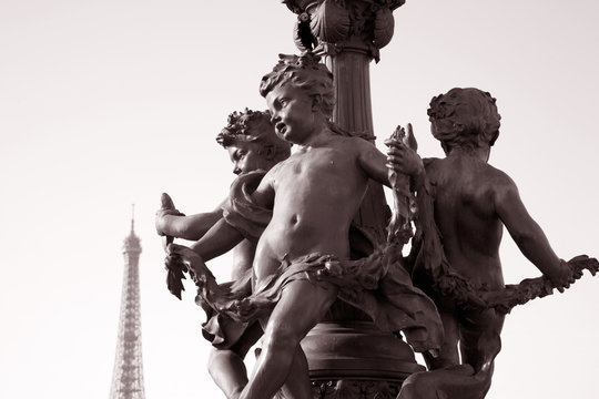 Fototapeta Figure on Pont Alexandre III Bridge with the Eiffel Tower in the Background in Sepia Black and White Tone in Paris, France